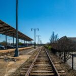 Straight railway lines in downtown Memphis, Tennessee with clear blue sky and urban elements.